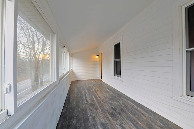 unfurnished sunroom featuring lofted ceiling