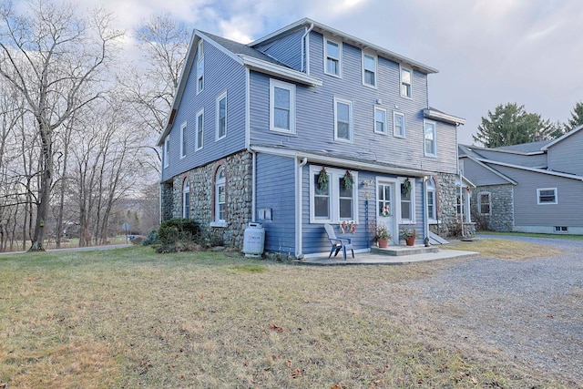 rear view of property with a yard