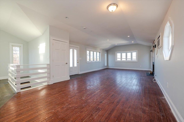 unfurnished living room featuring dark wood-type flooring and vaulted ceiling