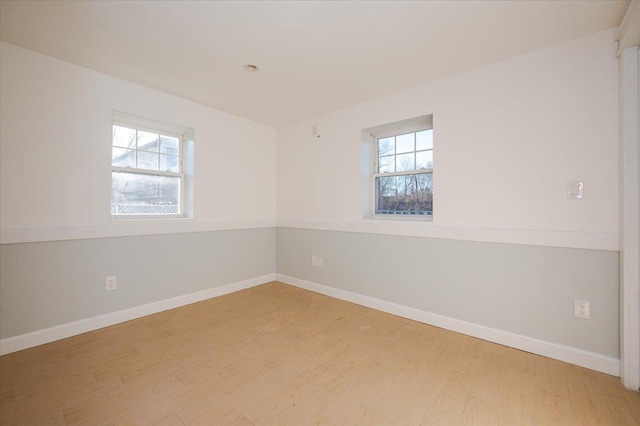 empty room featuring hardwood / wood-style floors and a healthy amount of sunlight