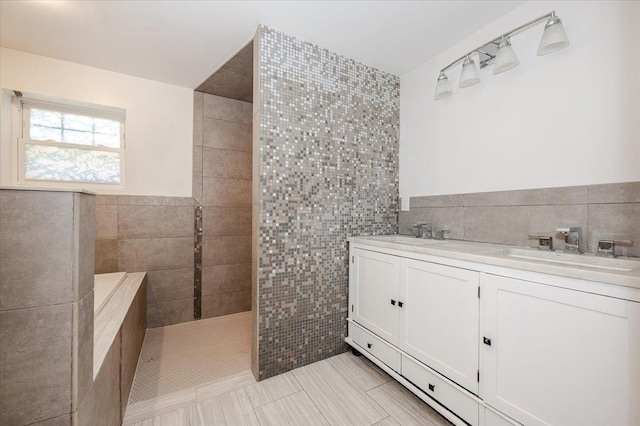 bathroom with tile patterned flooring, vanity, a shower, and tile walls