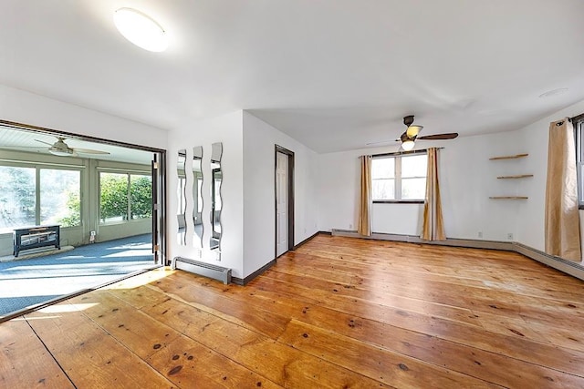 interior space featuring a baseboard radiator, ceiling fan, and light hardwood / wood-style floors