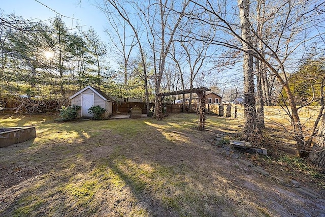 view of yard featuring a storage unit and a pergola