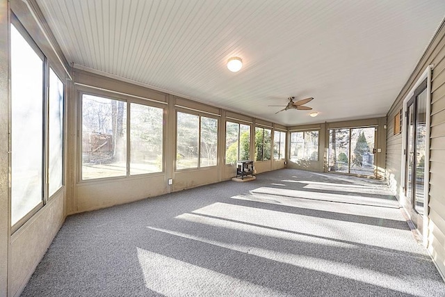 unfurnished sunroom with ceiling fan and plenty of natural light