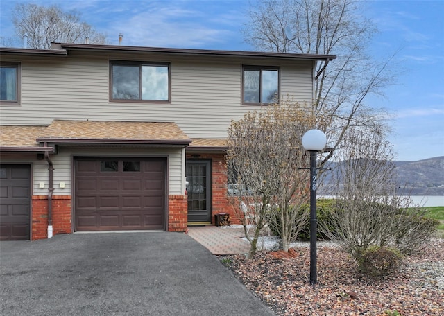 528 Barberry Ln, New Windsor, NY 12553 - view of front of house featuring an attached garage, brick siding, driveway, and a shingled roof