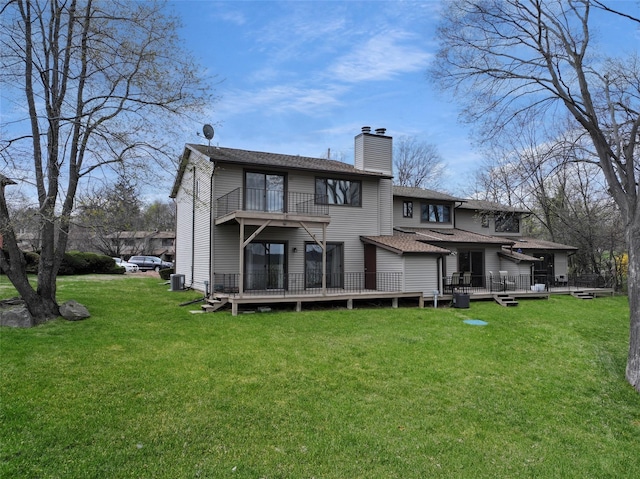 528 Barberry Ln, New Windsor, NY 12553 - rear view of house featuring roof with shingles, a chimney, a wooden deck, a lawn, and a balcony