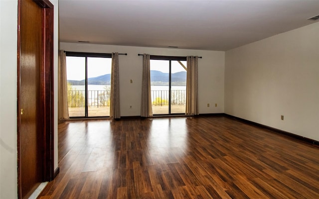 528 Barberry Ln, New Windsor, NY 12553 - unfurnished room with baseboards, dark wood-type flooring, and a mountain view