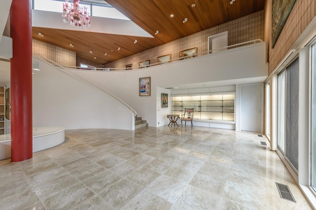 interior space featuring wood ceiling and a high ceiling