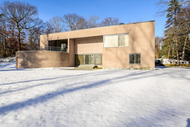 view of snow covered rear of property