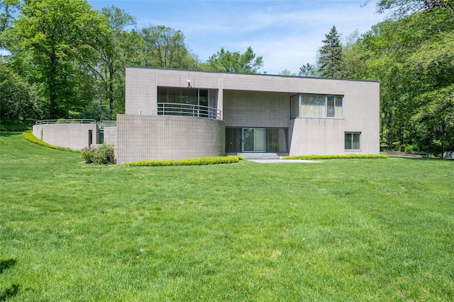 3 Paddock Ct, Old Westbury, NY 11568 - view of front facade with a front lawn and a balcony