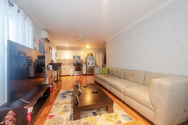 living room with a wall mounted air conditioner, ceiling fan, crown molding, and light hardwood / wood-style flooring