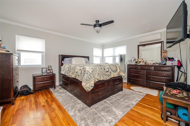 bedroom featuring multiple windows, ceiling fan, hardwood / wood-style floors, and ornamental molding