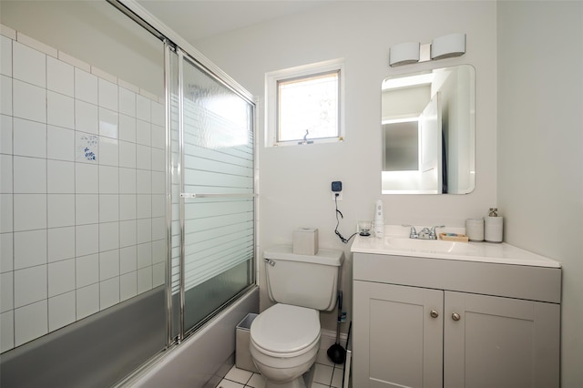 full bathroom with tile patterned flooring, vanity, toilet, and bath / shower combo with glass door