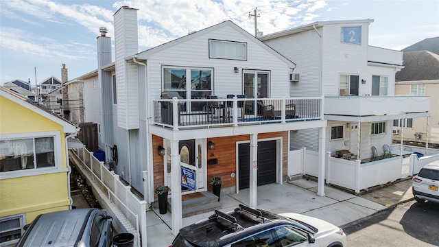 back of house featuring a balcony