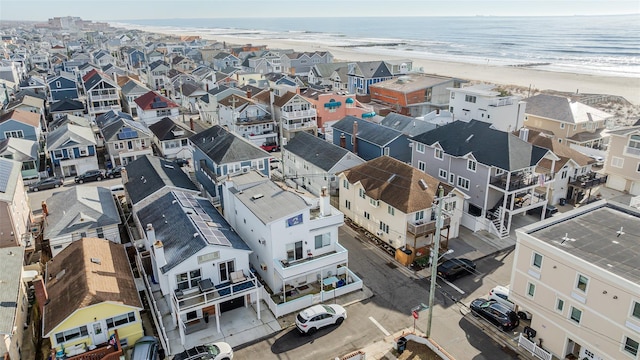 bird's eye view featuring a water view and a beach view