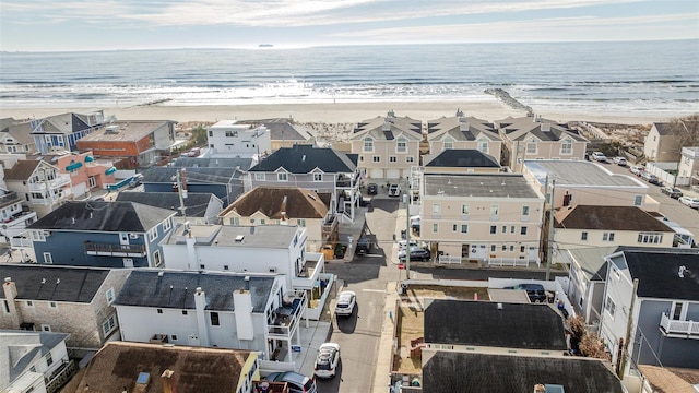 aerial view featuring a view of the beach and a water view