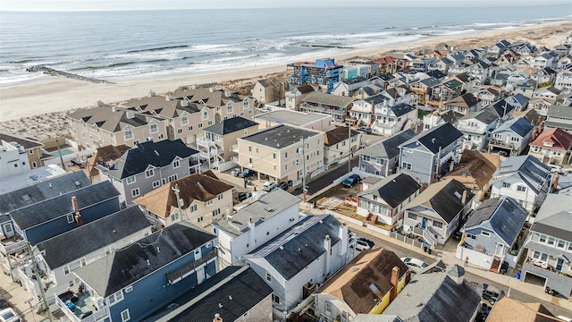 drone / aerial view with a water view and a view of the beach