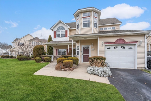 view of front of home with a front yard and a garage