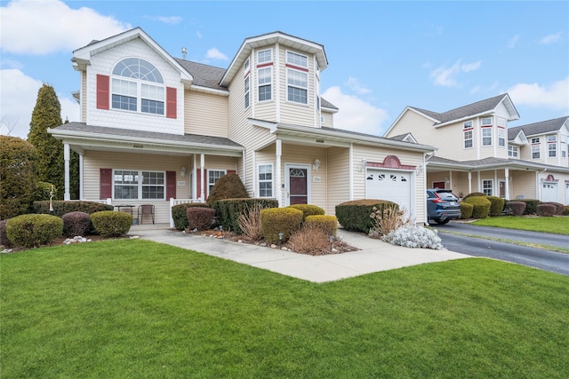 view of front of home with a porch, a garage, and a front lawn