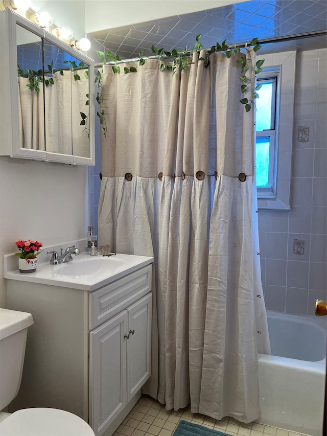 full bathroom with toilet, shower / tub combo, vanity, and tile patterned floors