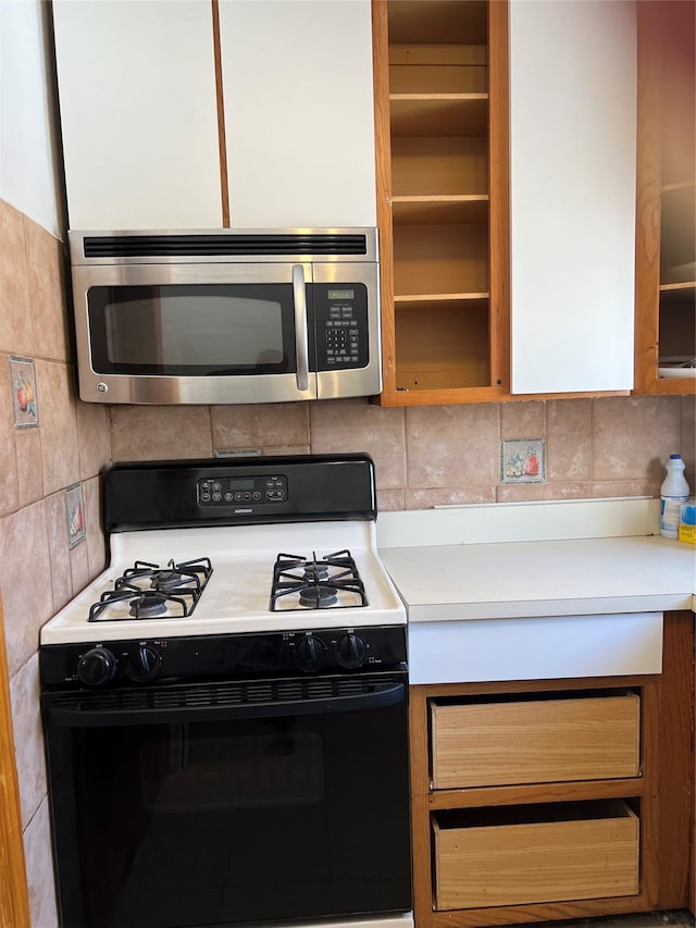 kitchen featuring tasteful backsplash and white gas stove