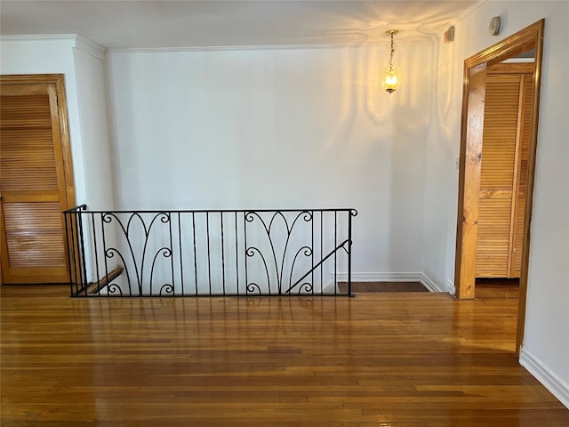 hall featuring wood-type flooring and crown molding