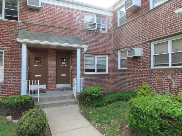 doorway to property with a wall unit AC and cooling unit