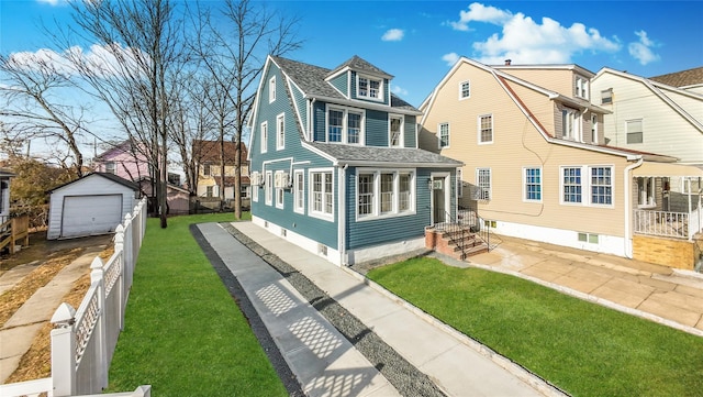 view of front of house with an outdoor structure, a front yard, and a garage