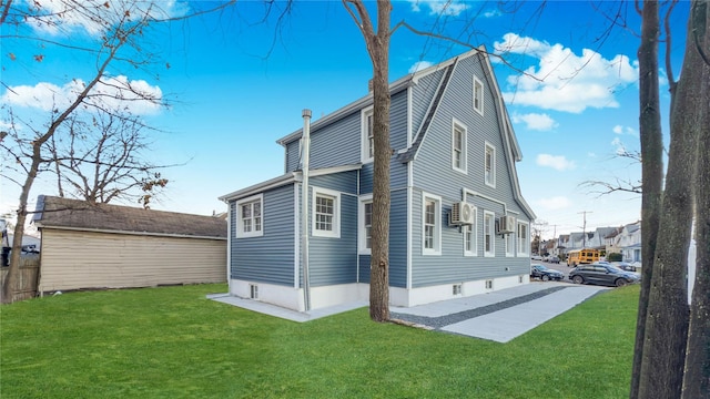 rear view of house with a patio and a lawn