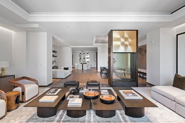 living room featuring a tray ceiling, recessed lighting, and wood finished floors