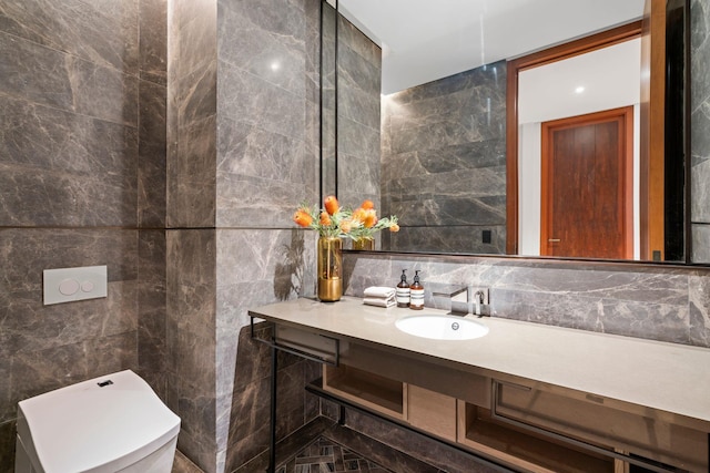 bathroom featuring toilet, tasteful backsplash, vanity, and tile walls