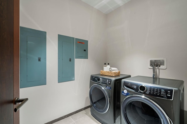 laundry room featuring laundry area, electric panel, and washing machine and clothes dryer