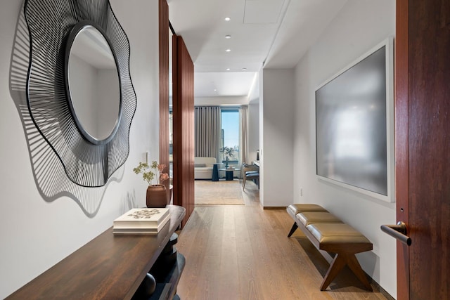 hall with light wood-type flooring and recessed lighting