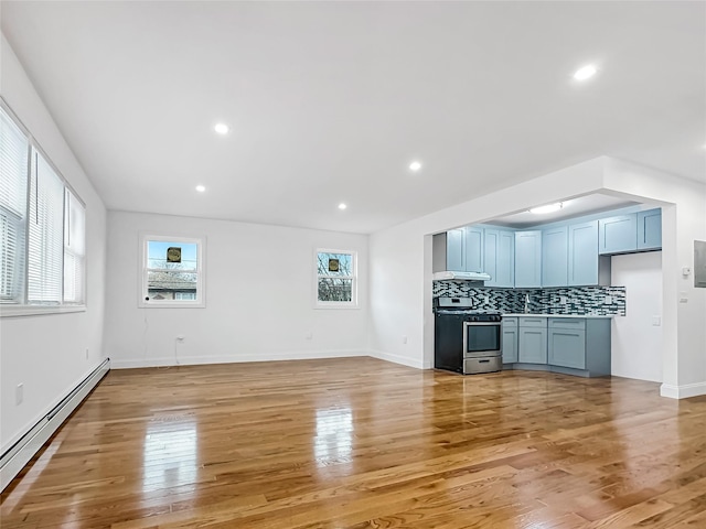 unfurnished living room featuring light wood-type flooring and baseboard heating