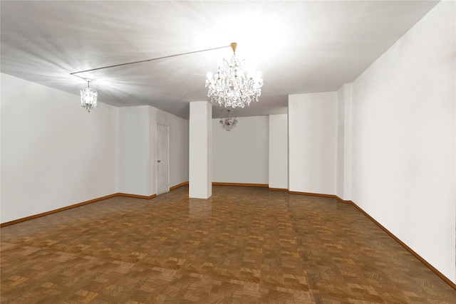 basement with dark parquet flooring and a chandelier