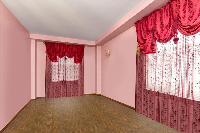 unfurnished room featuring parquet flooring