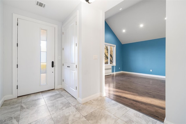 foyer entrance featuring light hardwood / wood-style floors and vaulted ceiling