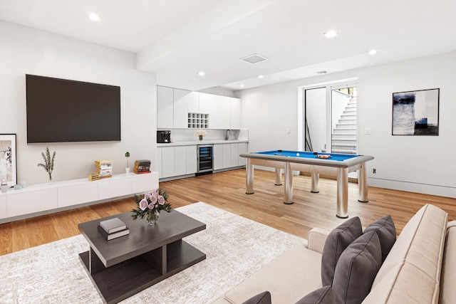 recreation room with light hardwood / wood-style flooring, beverage cooler, and billiards