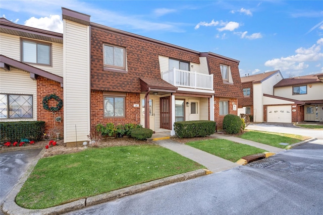 townhome / multi-family property with a garage and a front lawn