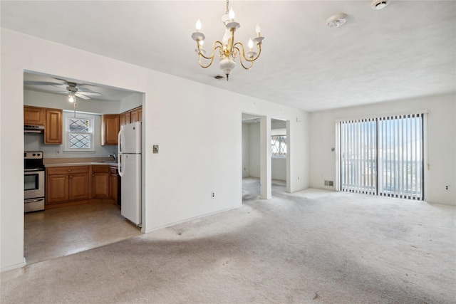 unfurnished living room with light carpet, sink, and ceiling fan with notable chandelier