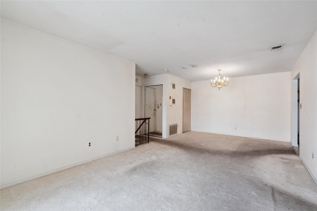 spare room featuring a notable chandelier