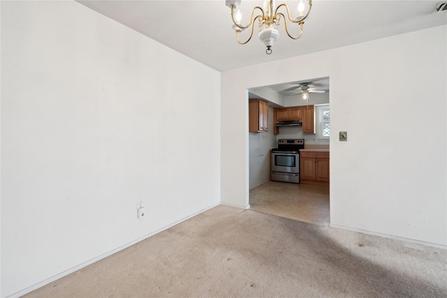 spare room featuring ceiling fan with notable chandelier