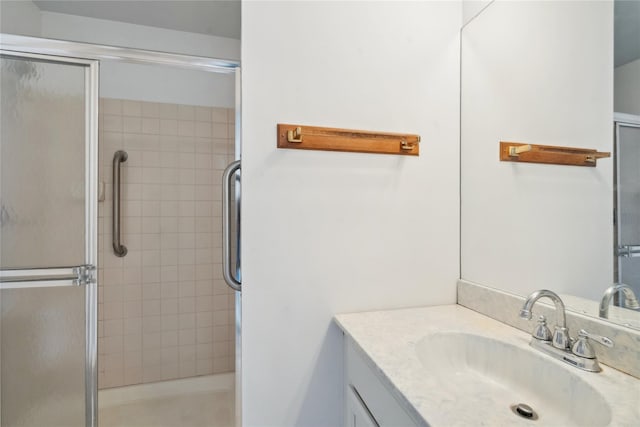 bathroom featuring vanity and a shower with shower door