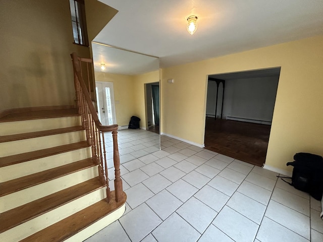 staircase with baseboard heating and tile patterned floors