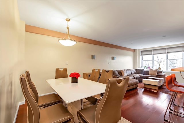 dining space with dark hardwood / wood-style flooring