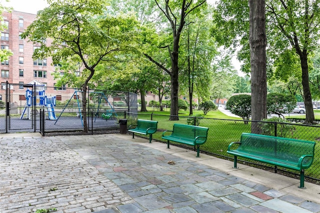 view of home's community featuring a playground and a yard