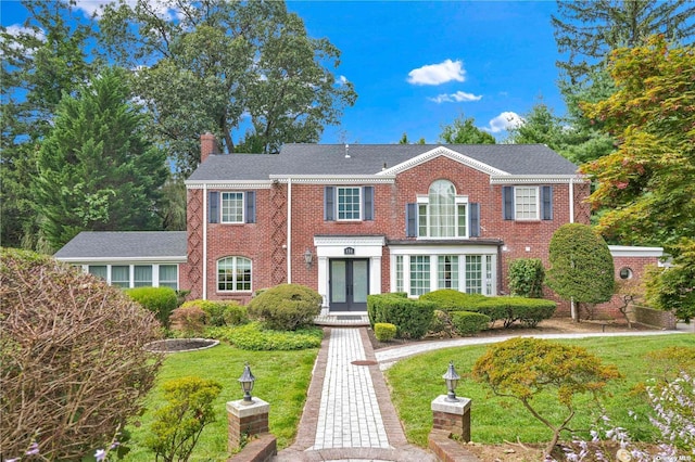 view of front of house featuring french doors and a front yard