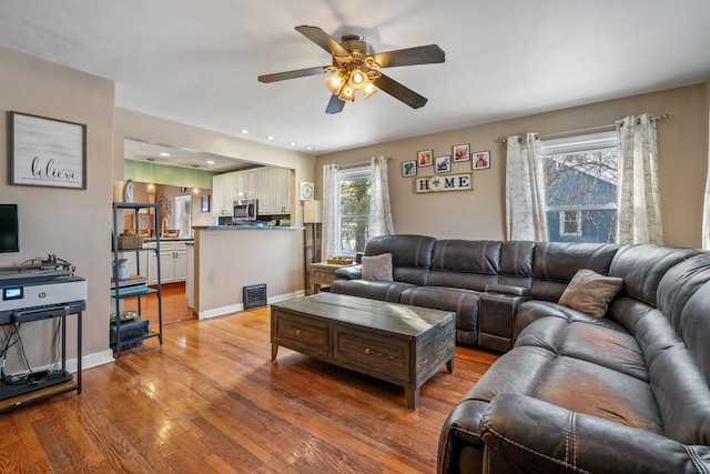 living room featuring hardwood / wood-style flooring and ceiling fan