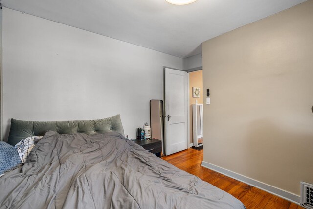 bedroom with wood-type flooring