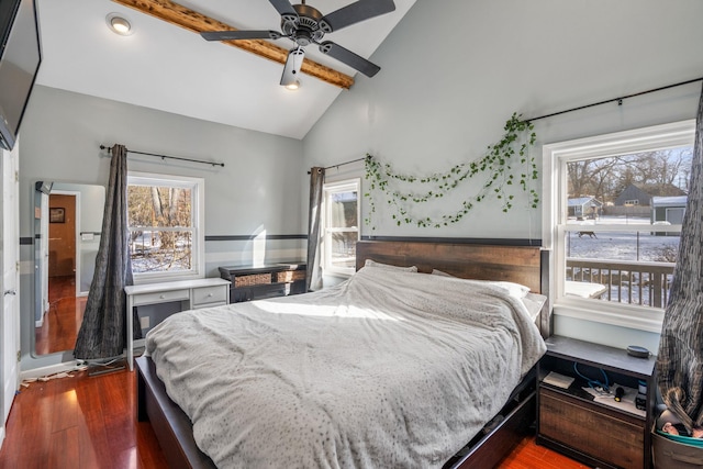 bedroom featuring lofted ceiling with beams, dark hardwood / wood-style floors, and ceiling fan